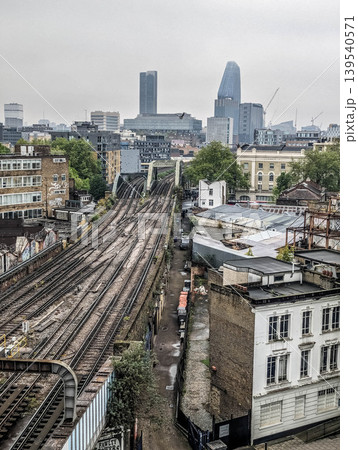 Urban Cityscape with Railway Tracks Dense Residential Buildings and Modern Metropolitan Skyline  139540571