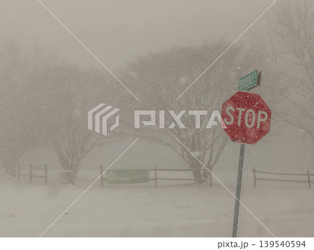 Stop Sign Visible in Heavy Snowstorm with Low Visibility and Blizzard Conditions on Rural Road Stop Sign Visible in Heavy Snowstorm with Low Visibility and Blizzard Conditions on Rural Road 139540594