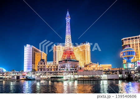 Paris Las Vegas Eiffel Tower replica and hotel casino illuminated at dusk along the Las Vegas Strip Paris Las Vegas Eiffel Tower replica and hotel casino illuminated at dusk along the Las Vegas Strip 139540606