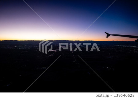 Aerial View of Denver Colorado at Sunset from Airplane Window with City Lights Rocky Mountains Aerial View of Denver Colorado at Sunset from Airplane Window with City Lights Rocky Mountains 139540628