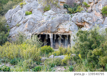 Ancient rock cut tombs carved into a limestone cliff face in Turkey Ancient rock cut tombs carved into a limestone cliff face in Turkey 139540795