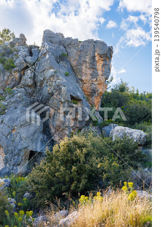 Ancient rock cut tomb in the mountainside at sunny day Ancient rock cut tomb in the mountainside at sunny day 139540798