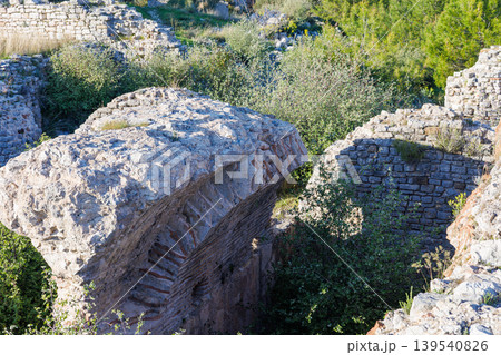 Ancient stone ruins surrounded by lush green Mediterranean vegetation Ancient stone ruins surrounded by lush green Mediterranean vegetation 139540826