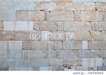Natural stone wall texture with rectangular blocks in warm earth tones Natural stone wall texture with rectangular blocks in warm earth tones 139540856