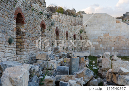 Ancient stone wall with arched niches at historic archeological ruins 139540867
