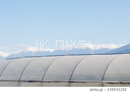 Greenhouse against snow covered mountains Greenhouse against snow covered mountains 139541292