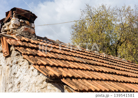 Old stone house roof with terracotta tiles Old stone house roof with terracotta tiles 139541581