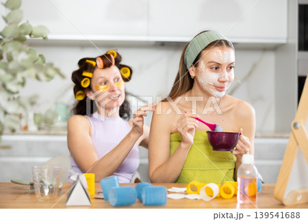 Female friends having pampering day, sharing skincare tips Female friends having pampering day, sharing skincare tips 139541688
