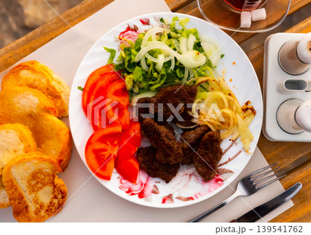 Turkish kofte, grilled veal meatballs with vegetables and bread Turkish kofte, grilled veal meatballs with vegetables and bread 139541762