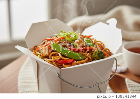 Steaming stir-fried noodles with tofu and vegetables in a takeout box Steaming stir-fried noodles with tofu and vegetables in a takeout box 139541844