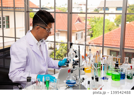 Professional scientist working in chemistry laboratory with microscope and colorful chemical glassware, conducting scientific research and biotechnology experiment for healthcare innovation Professional scientist working in chemistry laboratory with microscope and colorful chemical glassware, conducting scientific research and biotechnology experiment for healthcare innovation 139542488