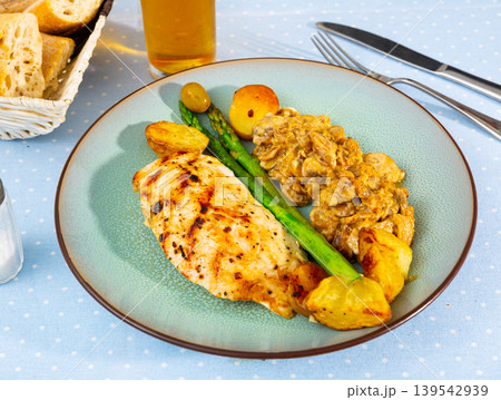Tasty baked chicken breast with mushrooms in sauce and potatoes Tasty baked chicken breast with mushrooms in sauce and potatoes 139542939