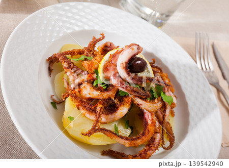 Roasted squid legs with lemon Roasted squid legs with lemon 139542940