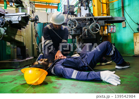 Emergency CPR by coworker after accident in industrial workplace Emergency CPR by coworker after accident in industrial workplace 139542984
