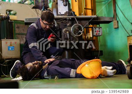 Factory worker calling emergency during industrial accident Factory worker calling emergency during industrial accident 139542989