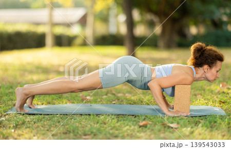 Adult woman doing yoga with blocks Adult woman doing yoga with blocks 139543033