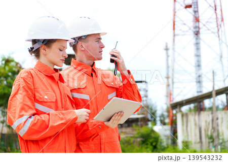 Engineers using tablet and radio at industrial site inspection Engineers using tablet and radio at industrial site inspection 139543232