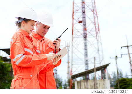 Engineers using tablet and radio at industrial site inspection Engineers using tablet and radio at industrial site inspection 139543234