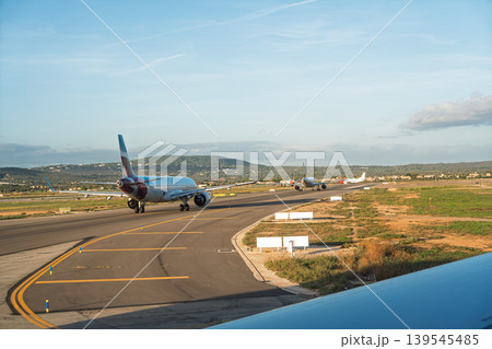 Airplanes on the runway at Palma de Mallorca Airport ready for takeoff on a sunny day 139545485