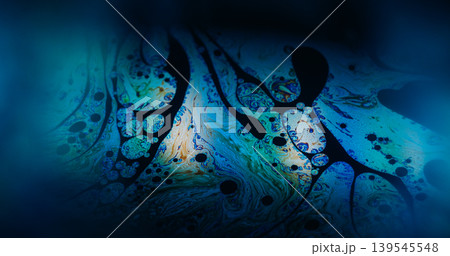 Holographic texture. Paint blend. Defocused blue purple orange color chemical round oil water liquid leak on abstract art dark black background. Holographic texture. Paint blend. Defocused blue purple orange color chemical round oil water liquid leak on abstract art dark black background. 139545548