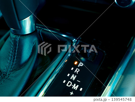Automatic car gear stick. Automatic transmission gear shift inside modern and sport design car. Gear stick shift on parking mode position. Park-transmission locked in position for parking. Automotive. 139545748