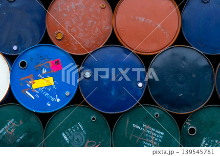 Old chemical barrels. Blue, green, orange oil drum. Steel oil tank. Toxic waste warehouse. Hazard chemical barrel with warning label. Industrial waste in metal drum. Hazard waste storage in factory. Old chemical barrels. Blue, green, orange oil drum. Steel oil tank. Toxic waste warehouse. Hazard chemical barrel with warning label. Industrial waste in metal drum. Hazard waste storage in factory. 139545781