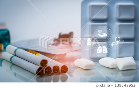 Quit smoking or smoking cessation with nicotine replacement therapy or NRT. 31 May World No Tobacco Day. Nicotine chewing gum in blister pack near pile of cigarettes. Nicotine products to stop smoke. Quit smoking or smoking cessation with nicotine replacement therapy or NRT. 31 May World No Tobacco Day. Nicotine chewing gum in blister pack near pile of cigarettes. Nicotine products to stop smoke. 139545952