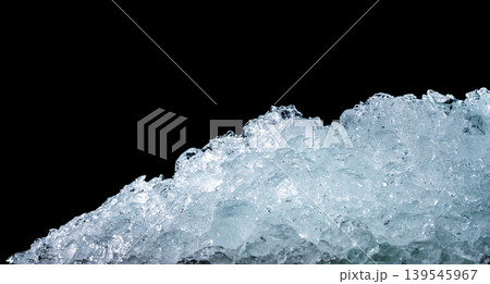 Pile of crushed ice cubes on dark background, cold fresh texture for beverages like beer whisky juice and milk, cooling concept for food preservation and refreshing drinks with crystal clear surface. 139545967