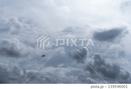 Aircraft flying in cloudy sky for rainmaking and artificial precipitation, agricultural aviation technology for cloud seeding. Weather modification, drought solution and environmental sustainability. Aircraft flying in cloudy sky for rainmaking and artificial precipitation, agricultural aviation technology for cloud seeding. Weather modification, drought solution and environmental sustainability. 139546001