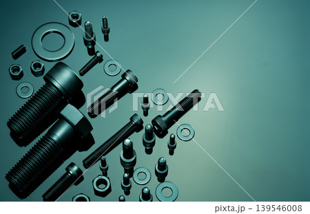 Metal Bolts, nuts, and washers. Fasteners equipment. Hardware tools. Stud bolt, flat washers, hex nuts, and hex head bolts in workshop. Threaded fastener use in automotive engineering. Hexagonal bolt. 139546008