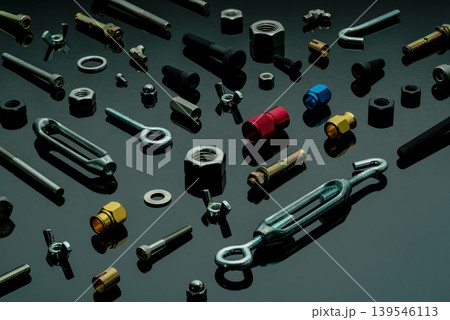 Metal bolts, nuts, and washers. Fasteners equipment. Hardware tools. Different types of nuts, bolts, and screws on table in workshop. Mechanic tools. Threaded fastener use in automotive engineering. Metal bolts, nuts, and washers. Fasteners equipment. Hardware tools. Different types of nuts, bolts, and screws on table in workshop. Mechanic tools. Threaded fastener use in automotive engineering. 139546113