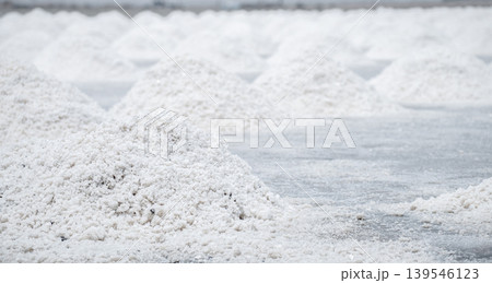 Sea salt farm. Pile of brine salt. Raw material of salt industrial. Sodium Chloride mineral. Evaporation and crystallization of sea water. White salt harvesting. Agriculture industry. Traditional farm 139546123