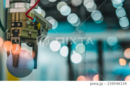 Robotic hand picking ball in factory, smart automation system in manufacturing industry. Precision engineering, artificial intelligence technology and modern industrial workflow. Automation technology 139546134
