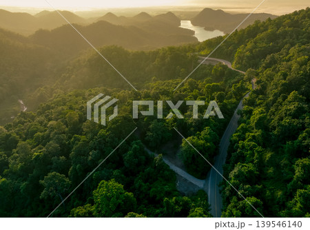 Landscape of green mountains with curve highway road and lake in the morning. Nature landscape. Watershed forest. Water and forest sustainability concept. Aerial view of mountain with green trees. Landscape of green mountains with curve highway road and lake in the morning. Nature landscape. Watershed forest. Water and forest sustainability concept. Aerial view of mountain with green trees. 139546140
