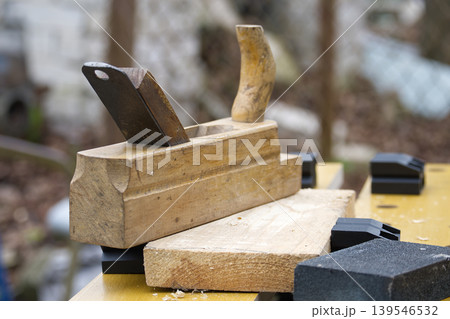 Wooden Hand Plane And Sanding Blocks On Workbench Showing Woodworking Tools And Rustic Craft Wooden Hand Plane And Sanding Blocks On Workbench Showing Woodworking Tools And Rustic Craft 139546532