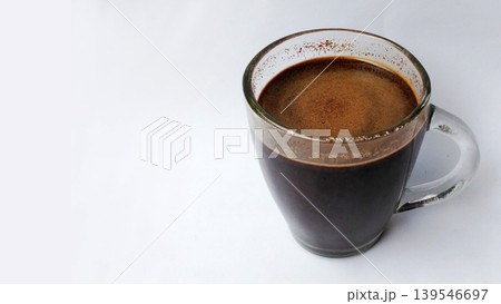Hot black coffee in a glass cup with crema on a white background. 139546697