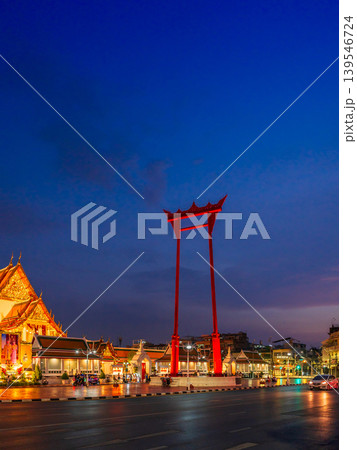 Beautiful night view of the illuminated Giant Swing and Wat Suthat temple architecture during twilight blue hour in Bangkok the city center Beautiful night view of the illuminated Giant Swing and Wat Suthat temple architecture during twilight blue hour in Bangkok the city center 139546724