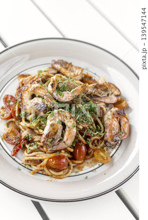shrimp and tomato diavolo spicy spaghetti on white table at outdoor restaurant in italy shrimp and tomato diavolo spicy spaghetti on white table at outdoor restaurant in italy 139547144