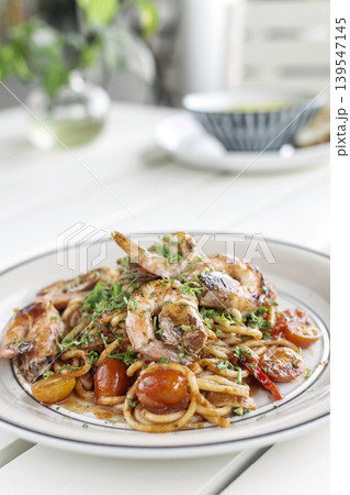 shrimp and tomato diavolo spicy spaghetti on white table at outdoor restaurant in italy shrimp and tomato diavolo spicy spaghetti on white table at outdoor restaurant in italy 139547145