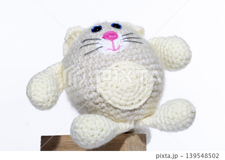 Knitted white cat on a white background Knitted white cat on a white background 139548502