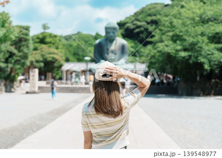 Woman tourist Visiting in Kamakura, Kanagawa prefecture , Japan. happy Traveler sightseeing the Great Buddha statue. Landmark and popular for tourists attraction near Tokyo. Travel and Vacation 139548977
