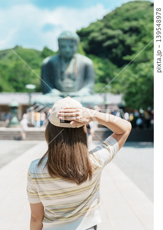 Woman tourist Visiting in Kamakura, Kanagawa prefecture , Japan. happy Traveler sightseeing the Great Buddha statue. Landmark and popular for tourists attraction near Tokyo. Travel and Vacation Woman tourist Visiting in Kamakura, Kanagawa prefecture , Japan. happy Traveler sightseeing the Great Buddha statue. Landmark and popular for tourists attraction near Tokyo. Travel and Vacation 139548978