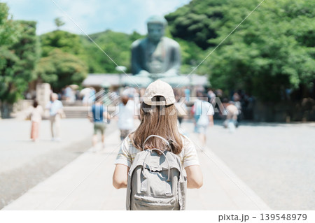 Woman tourist Visiting in Kamakura, Kanagawa prefecture , Japan. happy Traveler sightseeing the Great Buddha statue. Landmark and popular for tourists attraction near Tokyo. Travel and Vacation Woman tourist Visiting in Kamakura, Kanagawa prefecture , Japan. happy Traveler sightseeing the Great Buddha statue. Landmark and popular for tourists attraction near Tokyo. Travel and Vacation 139548979