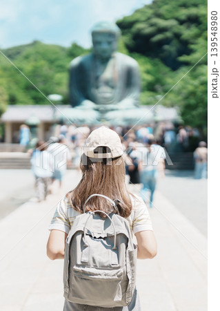 Woman tourist Visiting in Kamakura, Kanagawa prefecture , Japan. happy Traveler sightseeing the Great Buddha statue. Landmark and popular for tourists attraction near Tokyo. Travel and Vacation 139548980