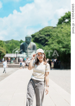 Woman tourist Visiting in Kamakura, Kanagawa prefecture , Japan. happy Traveler sightseeing the Great Buddha statue. Landmark and popular for tourists attraction near Tokyo. Travel and Vacation Woman tourist Visiting in Kamakura, Kanagawa prefecture , Japan. happy Traveler sightseeing the Great Buddha statue. Landmark and popular for tourists attraction near Tokyo. Travel and Vacation 139548985