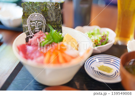 sashimi mixed fresh set japanese food with rice bowl. Salmon, Tuna fish, seafood and wasabi in restaurant. Kamakura Food with Buddha face is famous in Kangawa prefecture, Japan sashimi mixed fresh set japanese food with rice bowl. Salmon, Tuna fish, seafood and wasabi in restaurant. Kamakura Food with Buddha face is famous in Kangawa prefecture, Japan 139549008