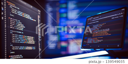 Cyber security concept and hacking. Multiple monitors with complex colorful script syntax in dark mode with shallow depth of field. Cyber security concept and hacking. Multiple monitors with complex colorful script syntax in dark mode with shallow depth of field. 139549035