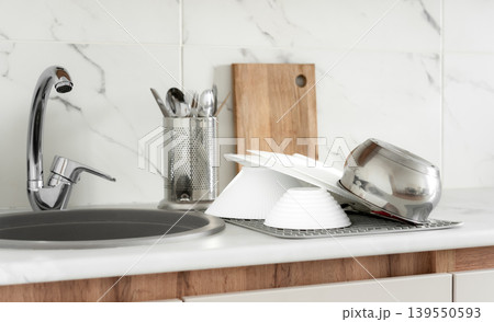 Clean dishes drying near kitchen sink 139550593