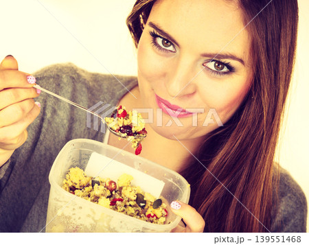 Woman eat oatmeal with dry fruits. Dieting Woman eat oatmeal with dry fruits. Dieting 139551468