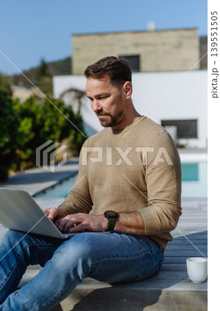 Man making online order or working from home on terrace. 139551505